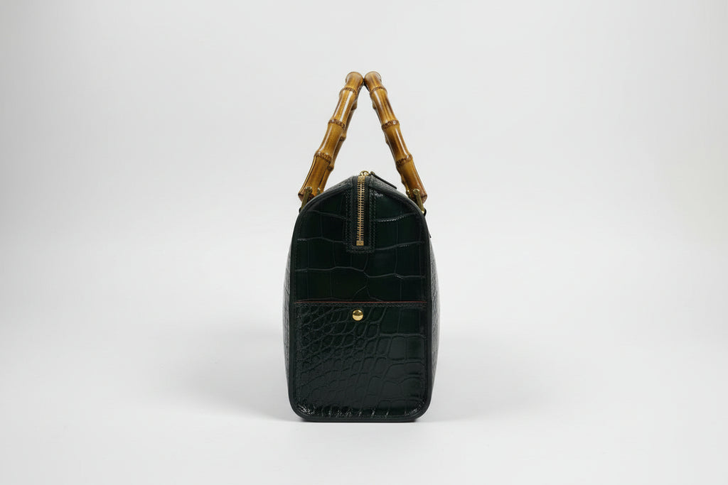 The Gabby Italian leather handbag in mock croc leather, bamboo handles in the color dark money green- side detail