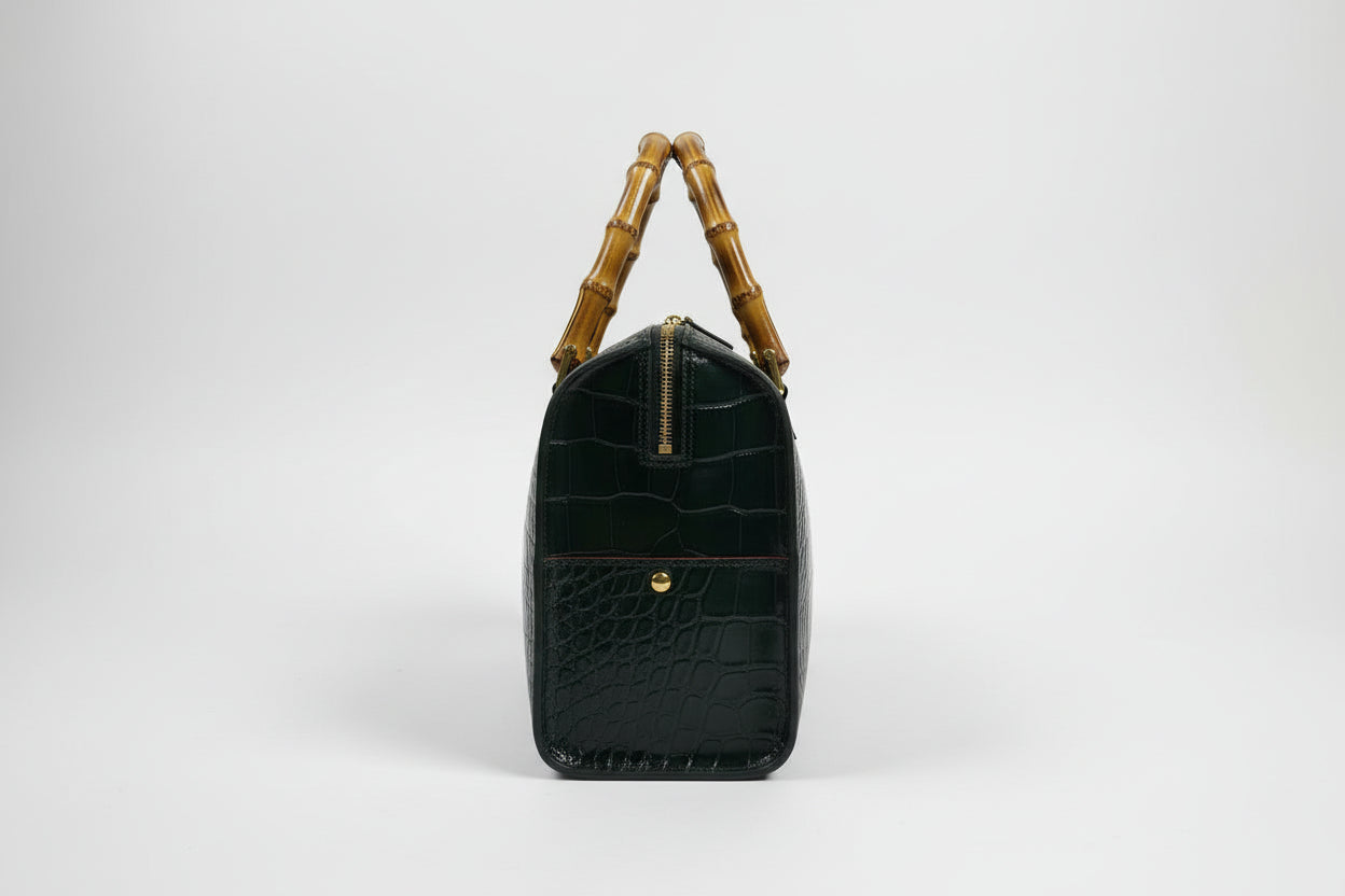 The Gabby Italian leather handbag in mock croc leather, bamboo handles in the color dark money green- side detail